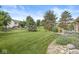 Spacious backyard with well-manicured lawn, bordered by rock garden and mature trees at 5659 Augusta Woods Dr, Plainfield, IN 46168