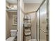 Bathroom featuring a corner shower, stacked towels, and a toilet with a shelf at 5659 Augusta Woods Dr, Plainfield, IN 46168