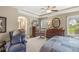 Spacious bedroom with a tray ceiling, an arched entrance to the bathroom, and warm neutral decor at 5659 Augusta Woods Dr, Plainfield, IN 46168