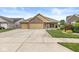 Beautiful single-story home with a spacious driveway, manicured lawn, and brick facade at 5659 Augusta Woods Dr, Plainfield, IN 46168