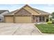 Charming brick home featuring a two-car garage, manicured lawn, and inviting curb appeal at 5659 Augusta Woods Dr, Plainfield, IN 46168