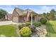 Well-maintained home with a brick facade, an American flag, and landscaped front yard at 5659 Augusta Woods Dr, Plainfield, IN 46168