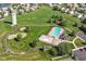 Aerial view featuring the community pool, playground, and green spaces for recreational activities and relaxation at 5765 White Pine Rd, Whitestown, IN 46075