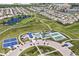 Beautiful aerial view showcases the community's playground, sports courts, green spaces, and serene pond at 5765 White Pine Rd, Whitestown, IN 46075