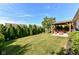 Lush backyard featuring a well-maintained lawn, mature trees, and outdoor seating area at 5765 White Pine Rd, Whitestown, IN 46075