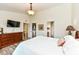 Bedroom with wood floor and dresser, TV, and ensuite bathroom and walk-in closet at 5765 White Pine Rd, Whitestown, IN 46075