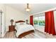 Comfortable bedroom showcases natural light, and a wood-framed bed at 5765 White Pine Rd, Whitestown, IN 46075