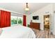 Bright bedroom featuring a large window, wooden dresser, and entry to the home at 5765 White Pine Rd, Whitestown, IN 46075