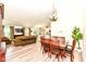 Open-concept dining area with natural light, adjacent to the living room and kitchen with wood-style flooring at 5765 White Pine Rd, Whitestown, IN 46075