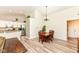 Bright dining area features modern lighting, wood table, and is adjacent to kitchen at 5765 White Pine Rd, Whitestown, IN 46075