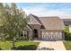 Charming brick home with a well-manicured lawn, beautiful landscaping, and an attached two-car garage at 5765 White Pine Rd, Whitestown, IN 46075