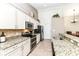 Well-equipped kitchen featuring granite countertops, stainless steel appliances, and custom cabinetry at 5765 White Pine Rd, Whitestown, IN 46075
