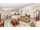 Spacious open-concept living room featuring wood floors, neutral paint, and combined seating and kitchen area at 5765 White Pine Rd, Whitestown, IN 46075