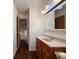 Bathroom featuring wood vanity and light pink countertops with a mirror and natural light at 5965 Deerwood Ct, Indianapolis, IN 46254