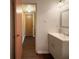 Bathroom with gray vanity and modern mirror, with convenient access to the hallway at 5965 Deerwood Ct, Indianapolis, IN 46254