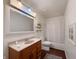 Well-lit bathroom showcasing a wood vanity, large mirror, and combined shower and tub at 5965 Deerwood Ct, Indianapolis, IN 46254