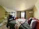Bright bedroom with olive-green accent wall, plush bed, and large window with patterned curtains at 5965 Deerwood Ct, Indianapolis, IN 46254