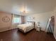 Airy bedroom with light pink accent wall, modern light fixture, and minimalist decor at 5965 Deerwood Ct, Indianapolis, IN 46254