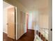 Bright hallway with wood flooring, closet, and clear views into adjacent rooms at 5965 Deerwood Ct, Indianapolis, IN 46254