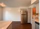 Kitchen features stainless steel refrigerator, light gray cabinets, and adjacent access to laundry room at 5965 Deerwood Ct, Indianapolis, IN 46254