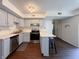 Bright kitchen features stainless steel appliances, light gray cabinets, and a breakfast bar with seating at 5965 Deerwood Ct, Indianapolis, IN 46254