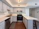 Bright kitchen features stainless steel appliances, light gray cabinets, and a breakfast bar with seating at 5965 Deerwood Ct, Indianapolis, IN 46254