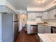 Bright kitchen features stainless steel appliances, light gray cabinets, and access to the laundry room at 5965 Deerwood Ct, Indianapolis, IN 46254