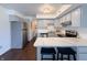 Bright kitchen features stainless steel appliances, light gray cabinets, and a breakfast bar with seating at 5965 Deerwood Ct, Indianapolis, IN 46254