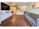 Inviting living room featuring a TV, hardwood floors, a staircase, and a comfortable grey sofa at 5965 Deerwood Ct, Indianapolis, IN 46254