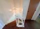 View down the staircase highlighting wood flooring and a decorative hanging light at 5965 Deerwood Ct, Indianapolis, IN 46254