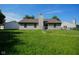The backyard features a fenced perimeter, green lawn, and privacy at 6029 Sycamore Forge Dr, Indianapolis, IN 46254