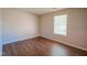 This bedroom includes wood-style flooring and a window offering natural light at 6029 Sycamore Forge Dr, Indianapolis, IN 46254