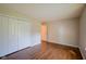 Bedroom features wood-style flooring, closet, and neutral color paint at 6029 Sycamore Forge Dr, Indianapolis, IN 46254