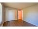 Bedroom features wood-style flooring, a closet, and neutral color paint at 6029 Sycamore Forge Dr, Indianapolis, IN 46254