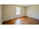 Bright bedroom with wood-style flooring and a window providing natural light at 6029 Sycamore Forge Dr, Indianapolis, IN 46254