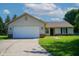 Charming ranch-style home with an attached two-car garage and well-manicured lawn at 6029 Sycamore Forge Dr, Indianapolis, IN 46254