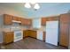 Well-lit kitchen featuring wooden cabinets and appliances at 6029 Sycamore Forge Dr, Indianapolis, IN 46254