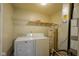 Functional laundry room with washer, dryer, storage shelf, and water heater at 6029 Sycamore Forge Dr, Indianapolis, IN 46254