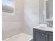 Bright bathroom with vanity, tub, and shower combo and marble styled wall tile at 615 Udell St, Indianapolis, IN 46208