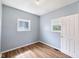 Bedroom featuring hardwood floors, light blue walls, and two windows at 615 Udell St, Indianapolis, IN 46208