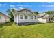 Charming home with a light gray exterior and a well-maintained lawn at 615 Udell St, Indianapolis, IN 46208