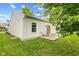 Well maintained backyard featuring a lawn, concrete patio with chairs and trees providing shade at 619 Cahill Ln, Indianapolis, IN 46214