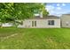 Well maintained backyard featuring a lawn, concrete patio with chairs and trees providing shade at 619 Cahill Ln, Indianapolis, IN 46214