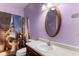 A unique bathroom with purple walls and novelty shower curtain creates a quirky, memorable space at 619 Cahill Ln, Indianapolis, IN 46214