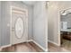 Inviting entryway with wood floors and a decorative door, leading into the home's interior at 619 Cahill Ln, Indianapolis, IN 46214