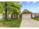 Charming single-story brick home with a well-manicured lawn and a two-car attached garage at 619 Cahill Ln, Indianapolis, IN 46214