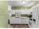 A well-lit kitchen with white cabinets and modern appliances, ideal for cooking and entertaining at 619 Cahill Ln, Indianapolis, IN 46214