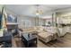 Bright living room with plush sectional sofa, fireplace, ceiling fan, and adjacent dining area at 619 Cahill Ln, Indianapolis, IN 46214