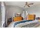 A serene main bedroom features light grey walls, a ceiling fan, and a large window for natural light at 619 Cahill Ln, Indianapolis, IN 46214