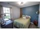 Comfortable bedroom with a cozy bed, dark wood desk, and a creative decorative wall at 740 Springmill Dr, Mooresville, IN 46158